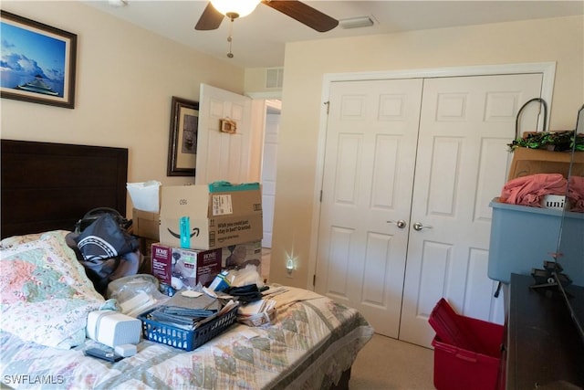 bedroom featuring a closet, carpet, visible vents, and a ceiling fan