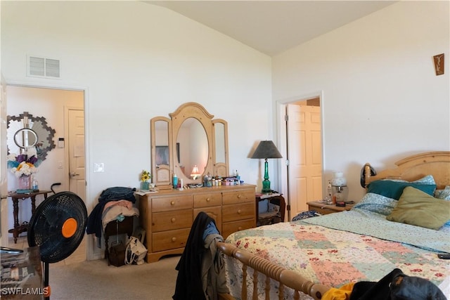 bedroom with vaulted ceiling, visible vents, and carpet floors