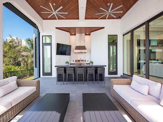 exterior space with fence, ceiling fan, a sink, outdoor lounge area, and a patio area