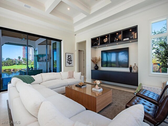 living area featuring coffered ceiling, beam ceiling, a high ceiling, ornamental molding, and tile patterned flooring