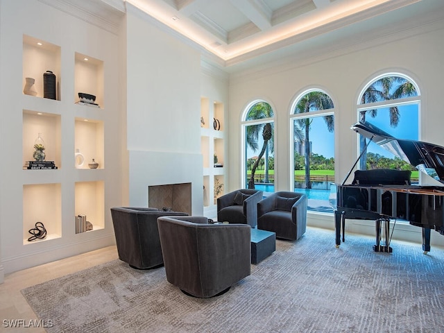 interior space with built in shelves, beam ceiling, coffered ceiling, crown molding, and a towering ceiling