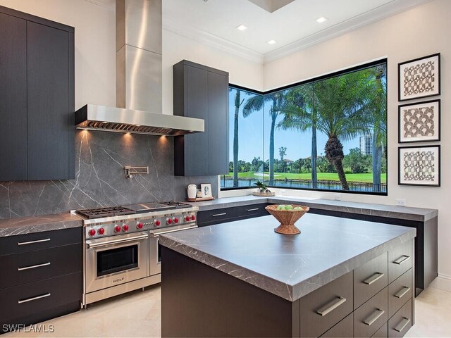 kitchen with double oven range, modern cabinets, wall chimney range hood, and ornamental molding