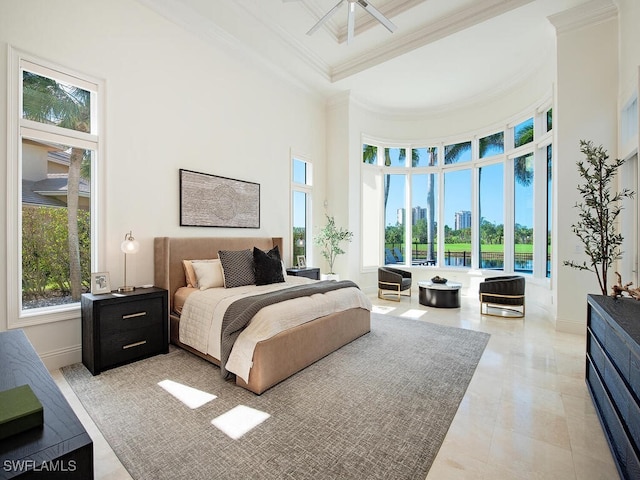 bedroom with light tile patterned floors, baseboards, a towering ceiling, a city view, and crown molding