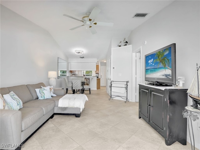 living area with lofted ceiling, light tile patterned floors, a ceiling fan, and visible vents