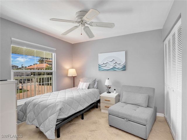 tiled bedroom with a ceiling fan