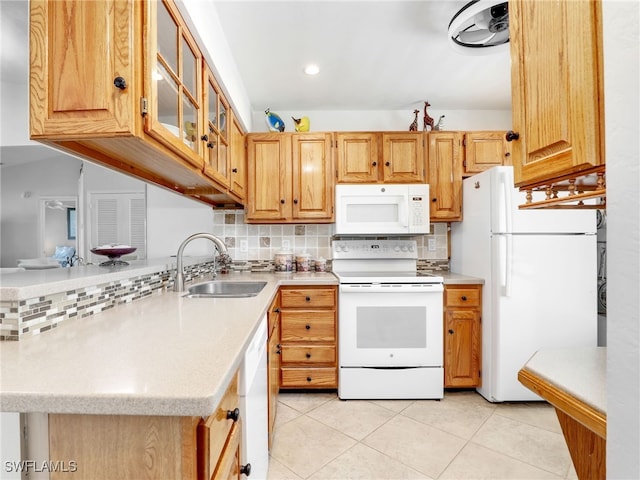 kitchen featuring a sink, white appliances, tasteful backsplash, and light countertops