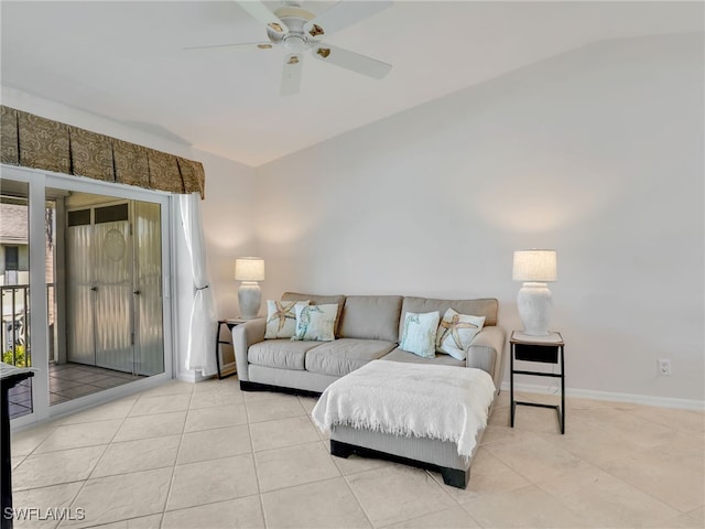 living room featuring light tile patterned floors, baseboards, and ceiling fan