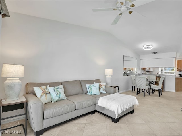 living room with light tile patterned floors, baseboards, visible vents, ceiling fan, and vaulted ceiling