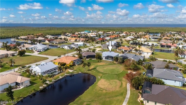 drone / aerial view with a residential view and a water view