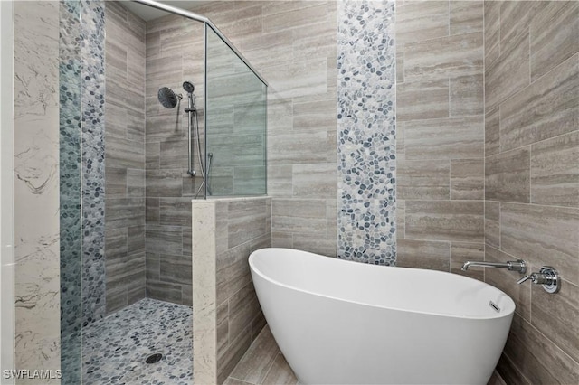 bathroom featuring a soaking tub, tile walls, and a tile shower