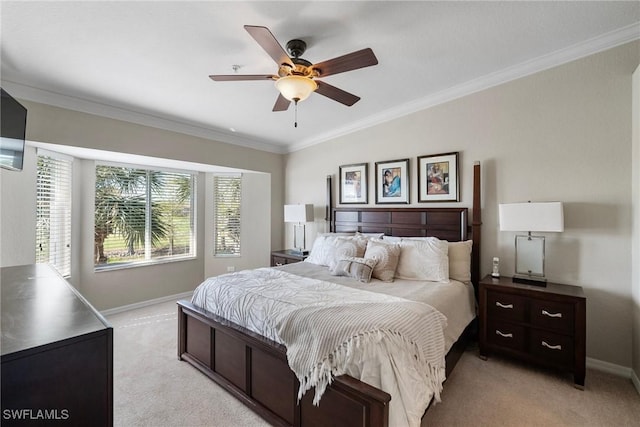 bedroom featuring light colored carpet, crown molding, baseboards, and ceiling fan