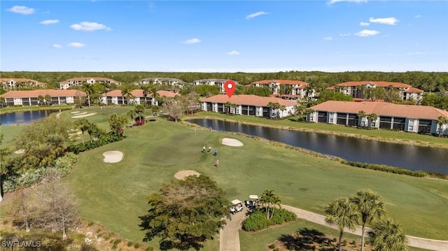 drone / aerial view featuring a residential view, view of golf course, and a water view