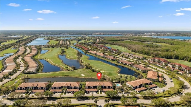 birds eye view of property with golf course view and a water view