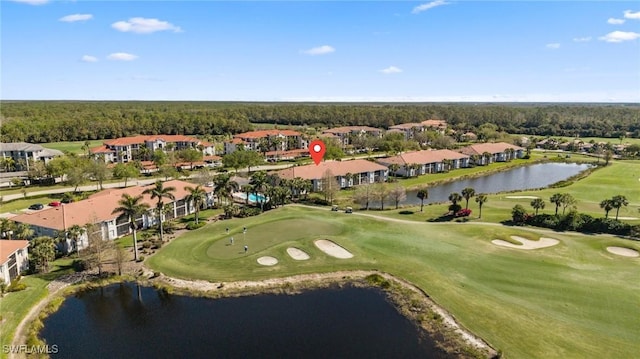 birds eye view of property with a water view and view of golf course