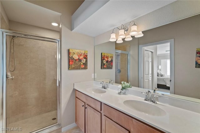 bathroom featuring double vanity, a stall shower, ensuite bath, and a sink