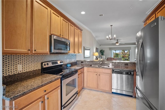 kitchen with light tile patterned flooring, a sink, decorative backsplash, stainless steel appliances, and crown molding