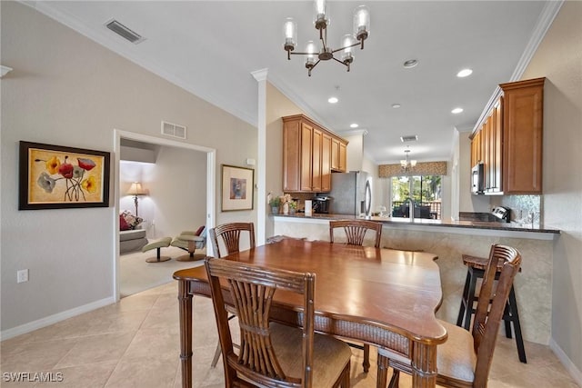 dining area featuring an inviting chandelier, light tile patterned floors, crown molding, and visible vents