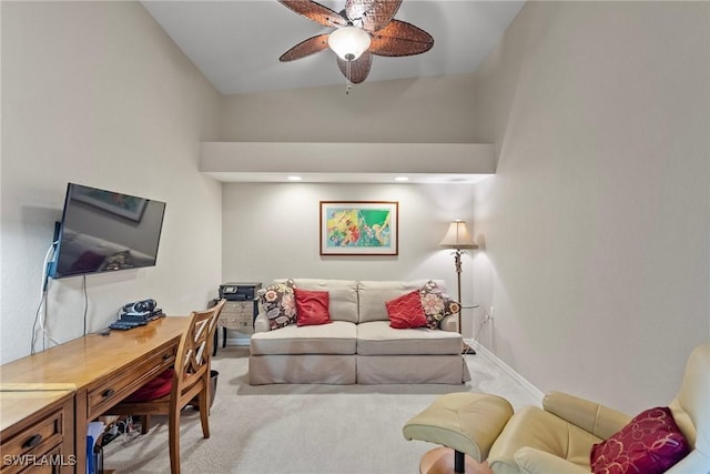 carpeted living area featuring a ceiling fan and baseboards