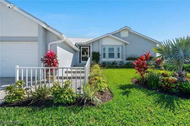 view of front facade with stucco siding, driveway, a front yard, and a garage