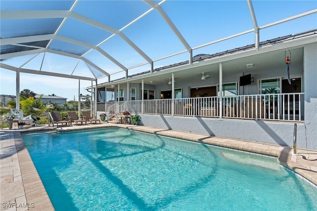 pool featuring a lanai, ceiling fan, and a patio area