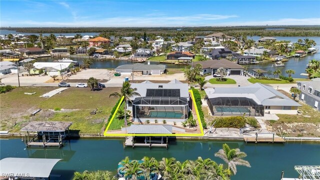 birds eye view of property with a water view and a residential view