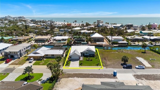 birds eye view of property featuring a water view and a residential view