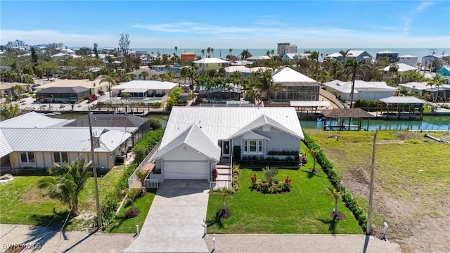 birds eye view of property featuring a residential view and a water view