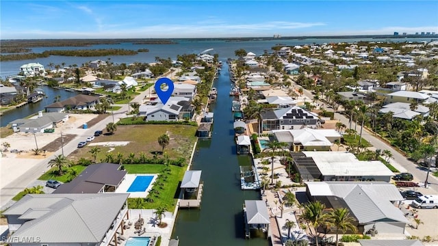 birds eye view of property featuring a residential view and a water view