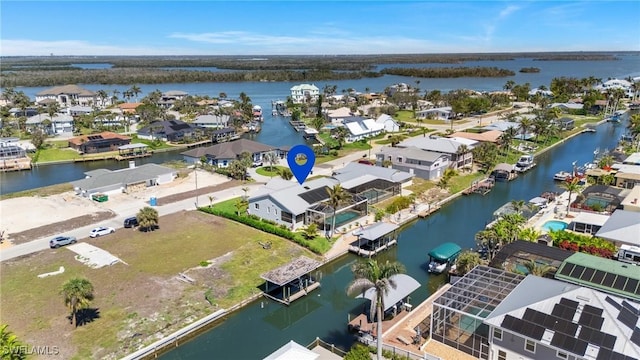 bird's eye view featuring a residential view and a water view