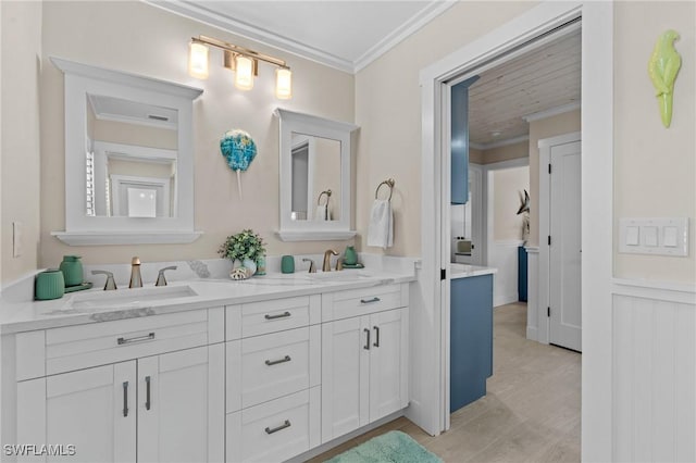 full bathroom featuring double vanity, ornamental molding, and a sink