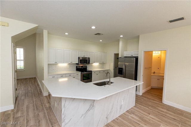 12391 Muddy Creek Ln, Fort Myers, FL 33913 - kitchen with stainless steel appliances, a sink, white cabinetry, baseboards, and recessed lighting