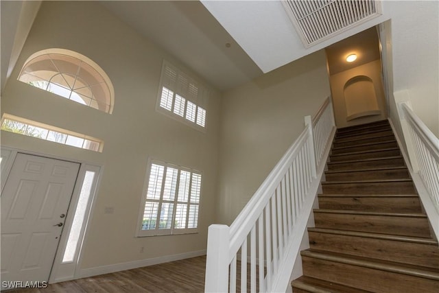 12391 Muddy Creek Ln, Fort Myers, FL 33913 - entryway featuring a high ceiling, stairs, and wood finished floors
