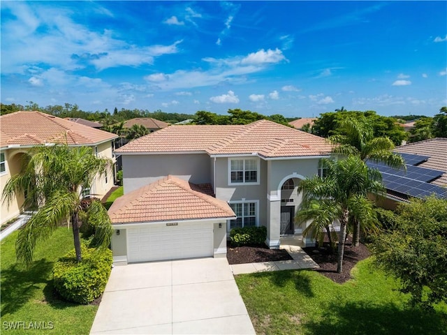 12391 Muddy Creek Ln, Fort Myers, FL 33913 - mediterranean / spanish-style home featuring a tile roof, stucco siding, driveway, and a front yard