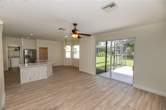 12391 Muddy Creek Ln, Fort Myers, FL 33913 - unfurnished living room with light wood finished floors and ceiling fan