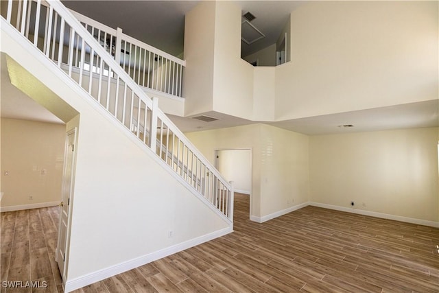 12391 Muddy Creek Ln, Fort Myers, FL 33913 - stairway featuring wood finished floors and a towering ceiling