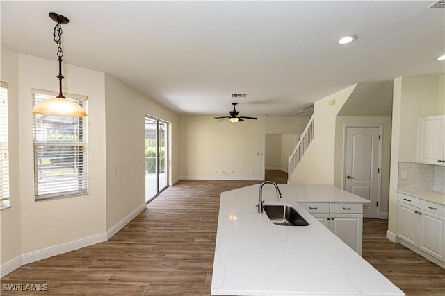 12391 Muddy Creek Ln, Fort Myers, FL 33913 - kitchen featuring ceiling fan, white cabinets, wood finished floors, recessed lighting, and decorative light fixtures