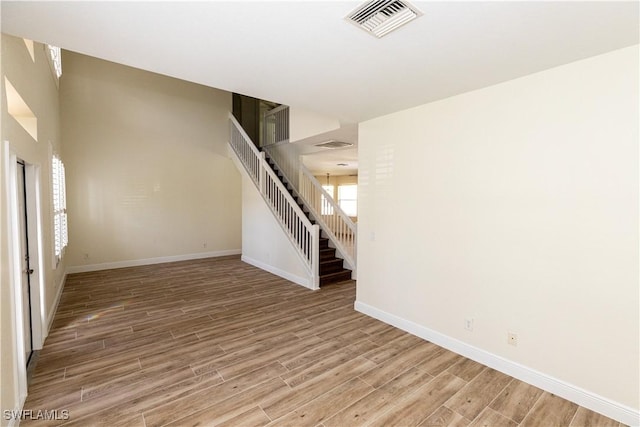 12391 Muddy Creek Ln, Fort Myers, FL 33913 - unfurnished room with light wood-style floors and stairway