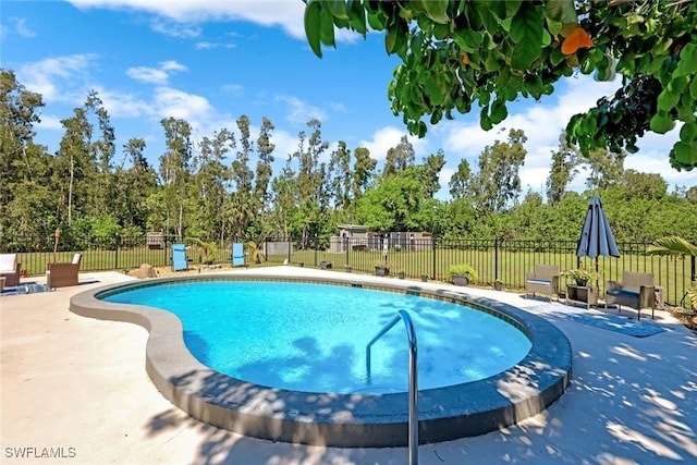 view of swimming pool with a patio, fence, and a fenced in pool