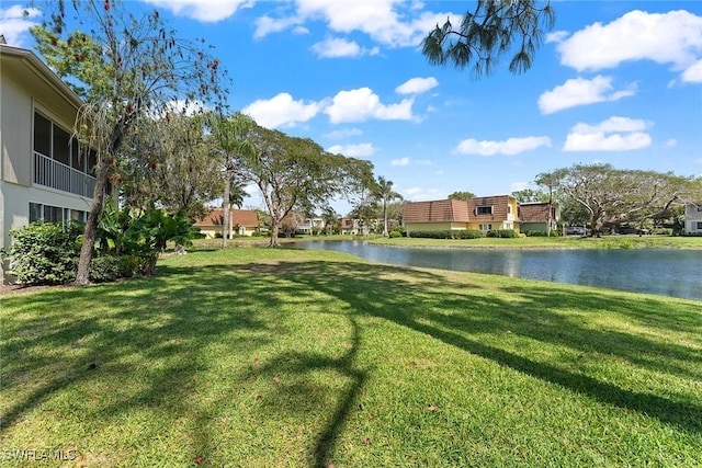 view of property's community featuring a yard and a water view