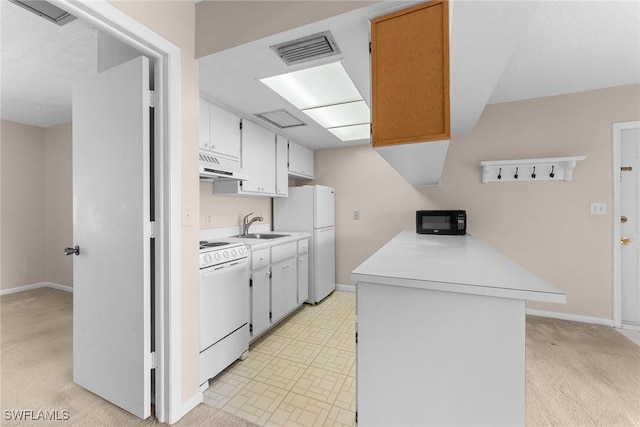 kitchen featuring visible vents, under cabinet range hood, light countertops, white appliances, and a sink