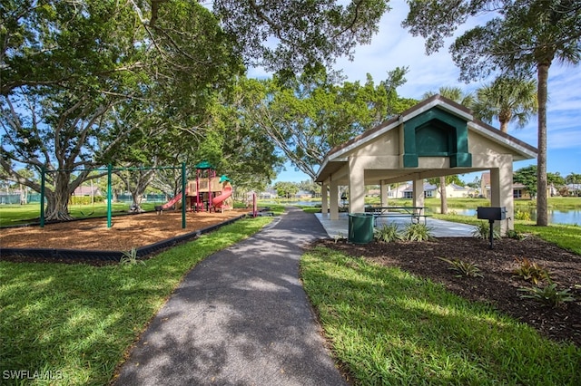 surrounding community with playground community and a yard