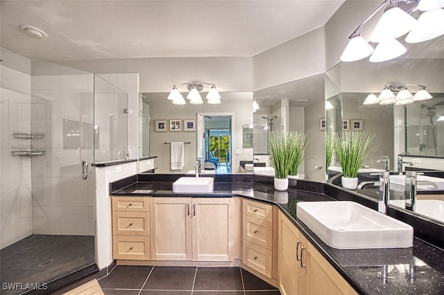 bathroom with a sink, a stall shower, and tile patterned floors