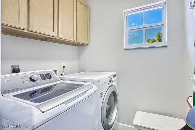 laundry room with cabinet space and washer and clothes dryer