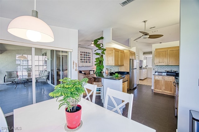 dining area with a ceiling fan and visible vents