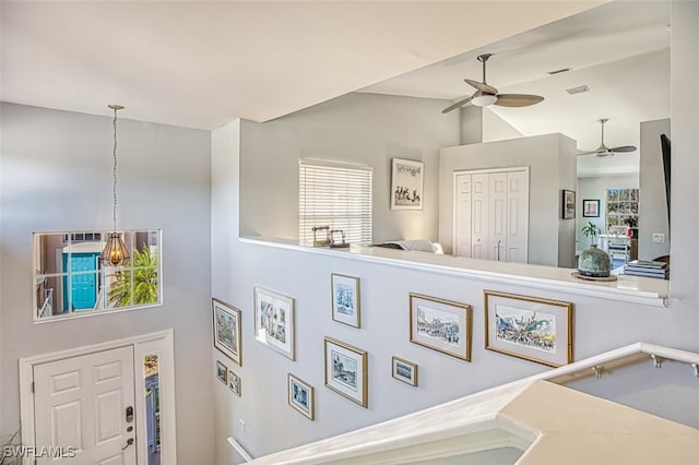 interior space with visible vents and ceiling fan