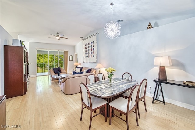 dining room featuring visible vents, baseboards, vaulted ceiling, light wood-style flooring, and a ceiling fan