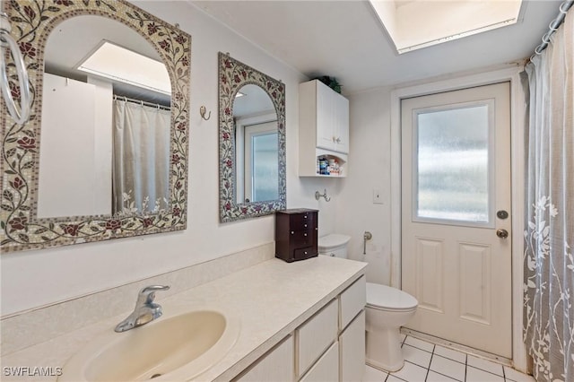 full bathroom featuring toilet, vanity, and tile patterned flooring