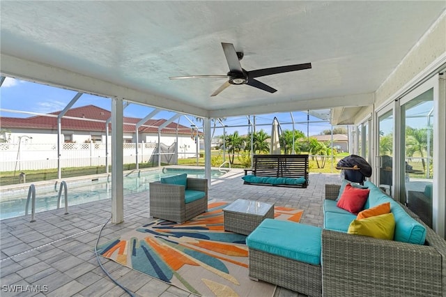 sunroom featuring a wealth of natural light and ceiling fan