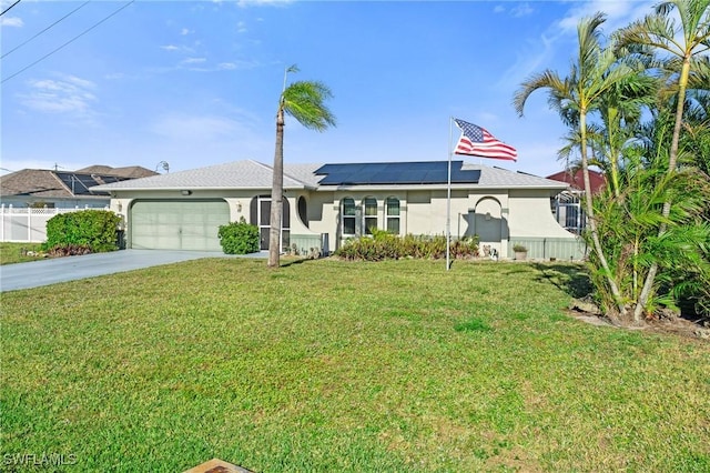 view of front of house with a garage, roof mounted solar panels, a front lawn, and stucco siding