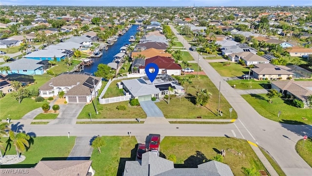 drone / aerial view with a residential view and a water view